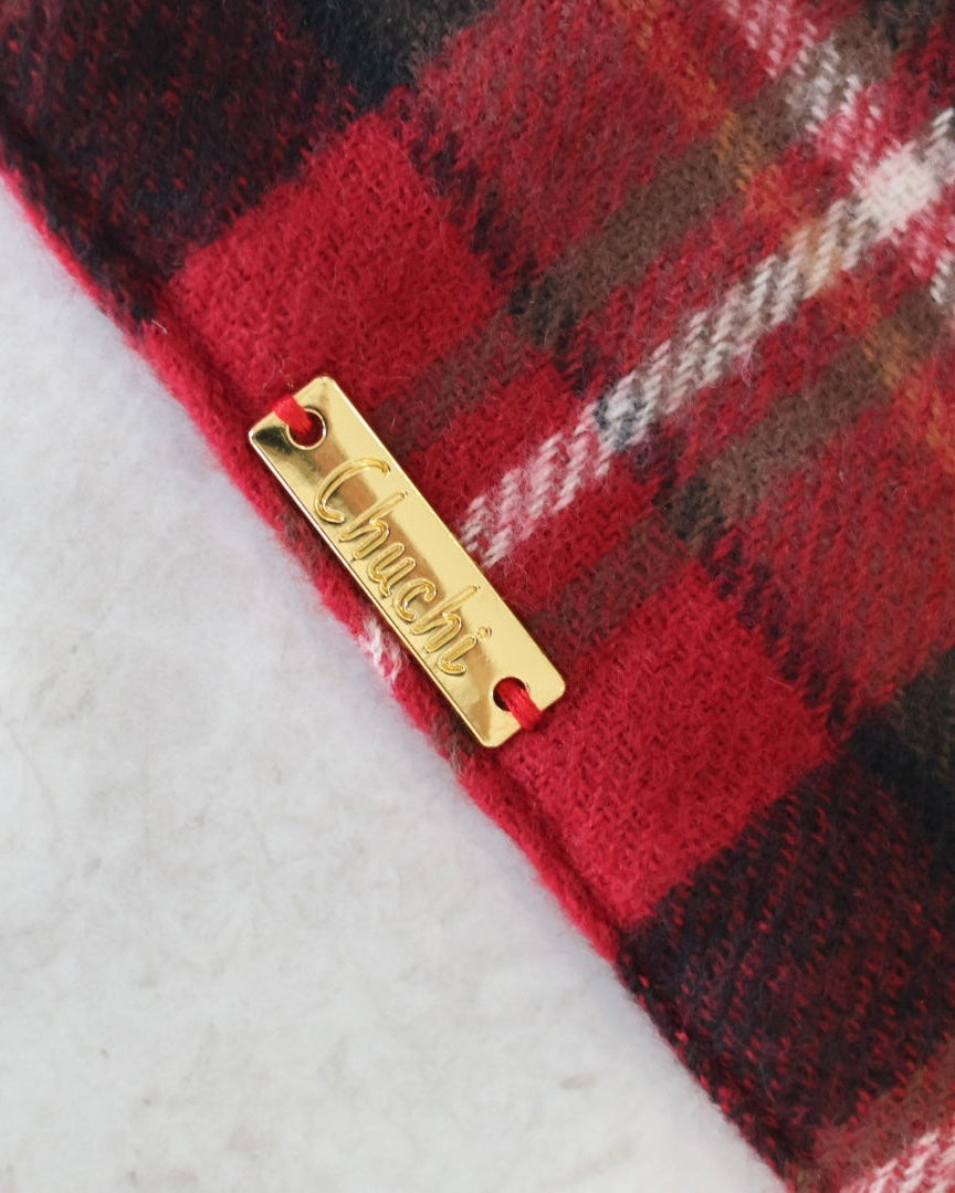 Plaid fabric with a gold tag on a white background