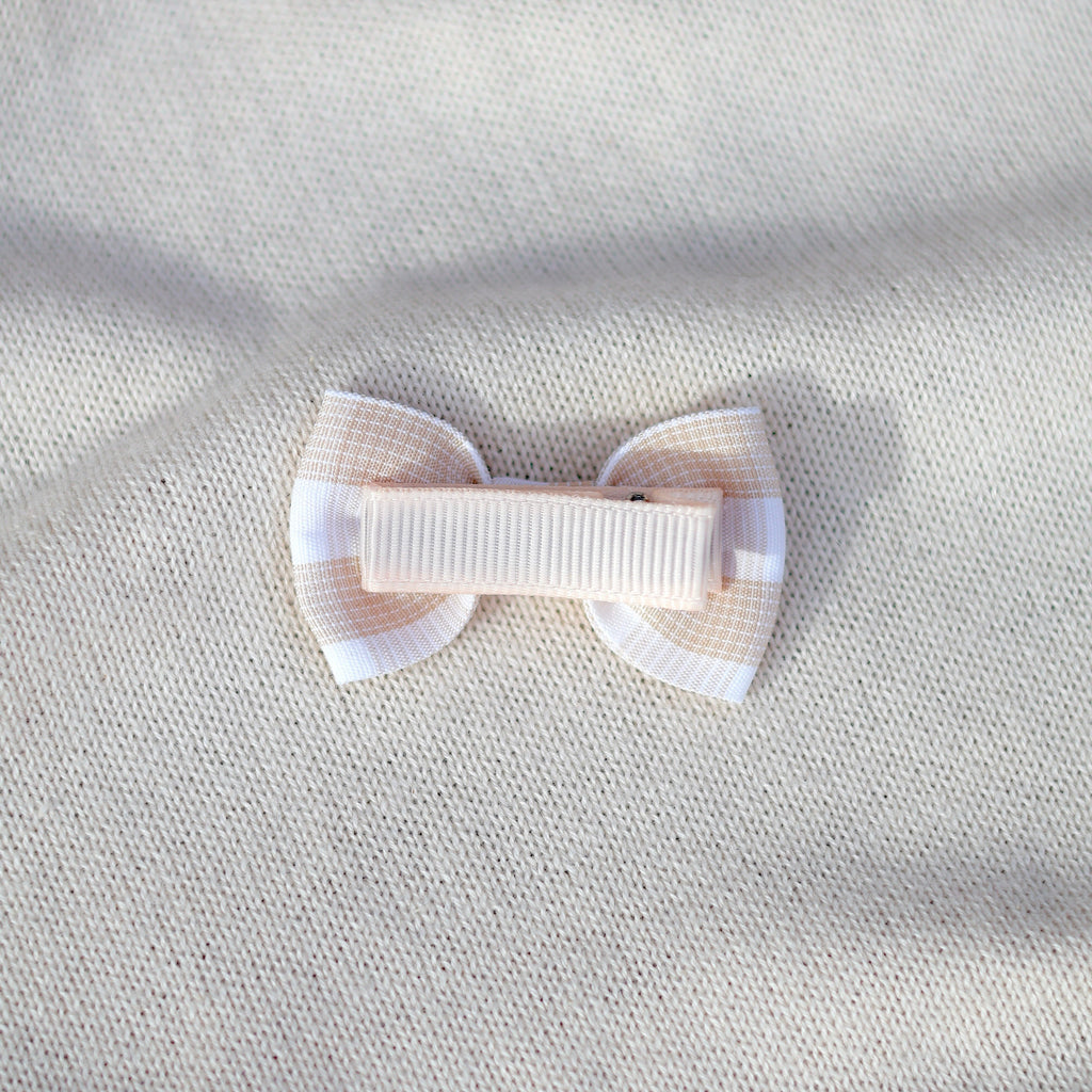 White bow on a textured beige background