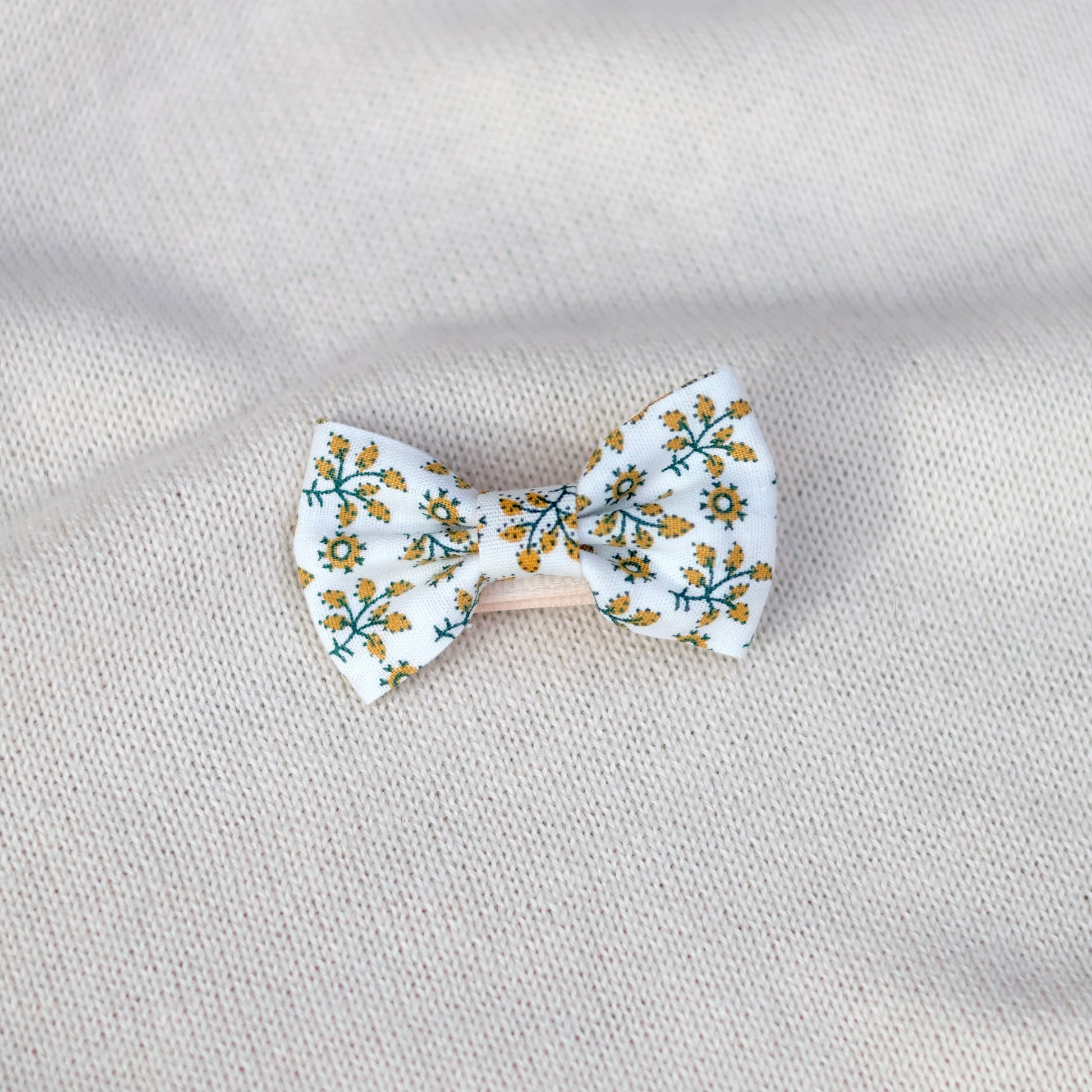 Floral bow tie on a textured gray background