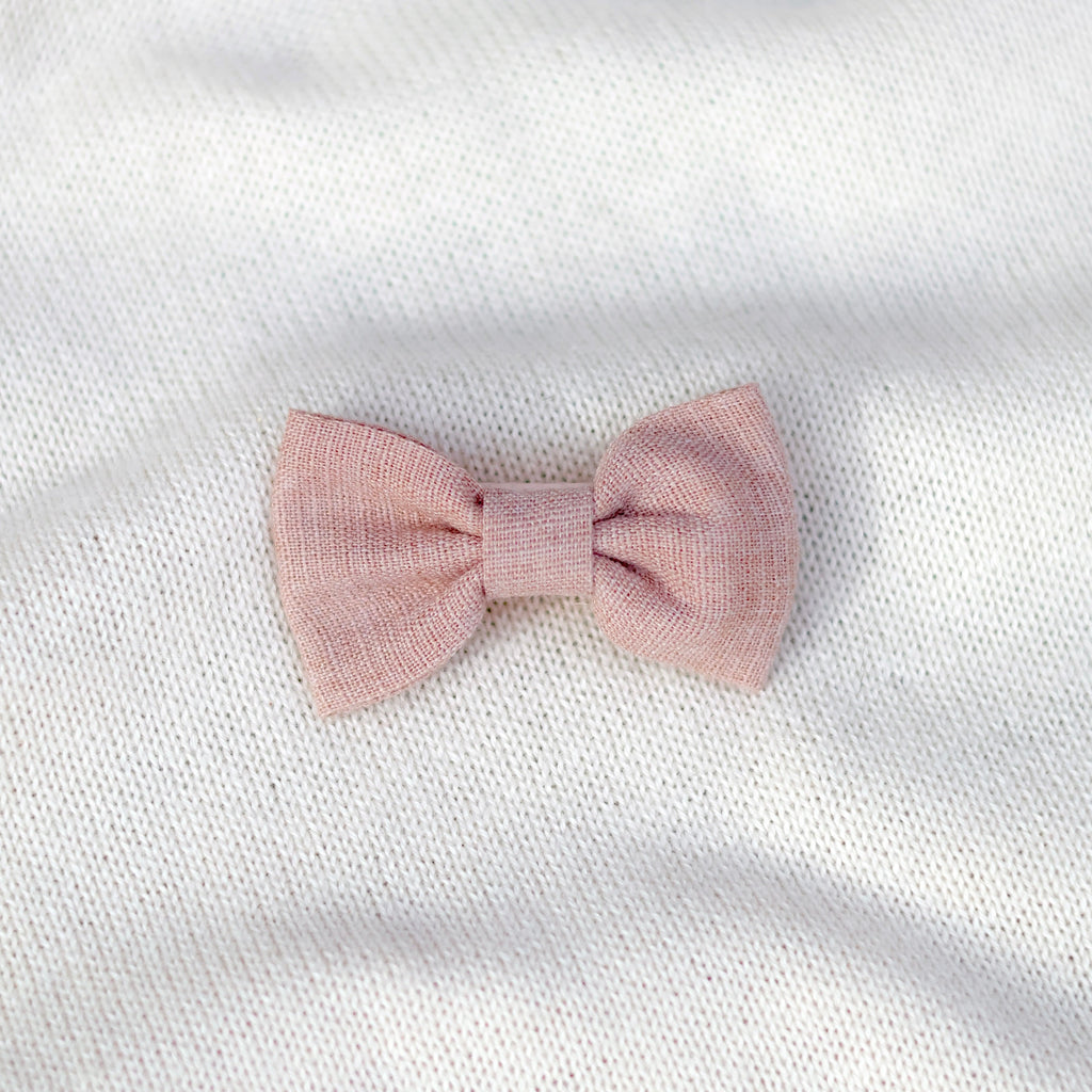Pink bow on a white textured background
